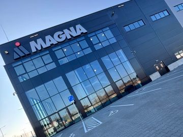 Modern building with MAGNA logo and glass facade.