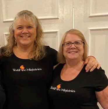 Two women Wearing black t shirt and looking on the front