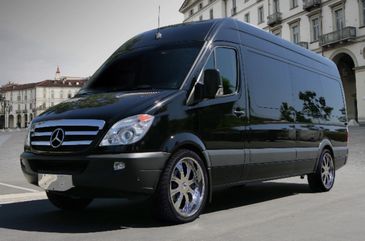 Black Mercedes-Benz van parked on a city street.