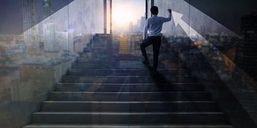 man climbing step of success 