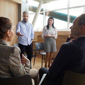 man coaching co workers