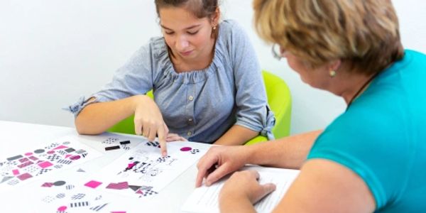 Female psychologist administering cognitive test to young girl