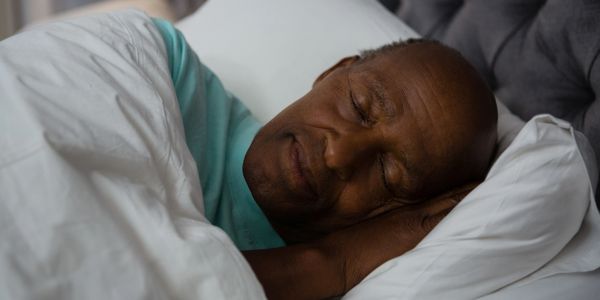 Middle-aged man lying asleep in bed