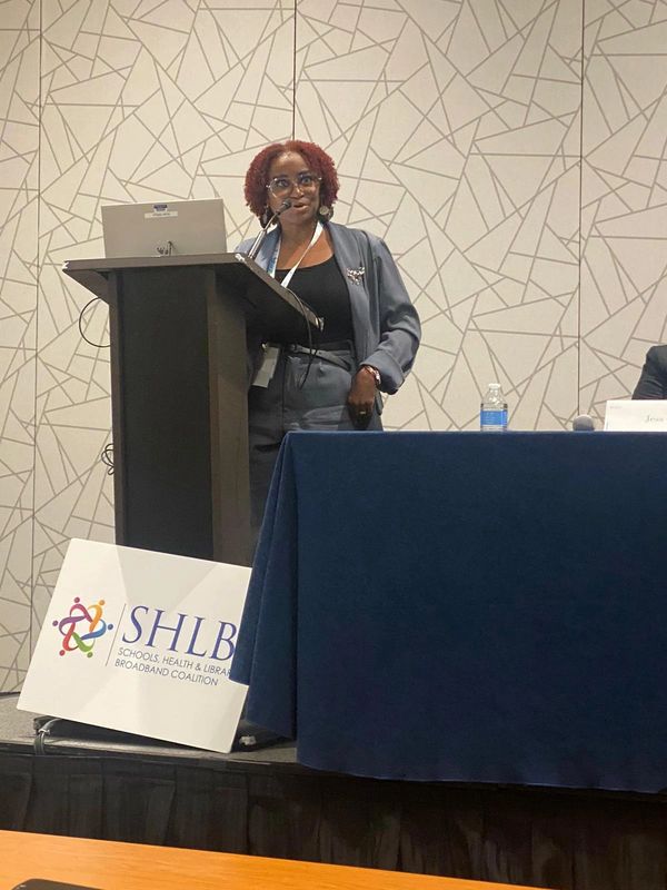 A woman speaks at a podium during a SHLB Coalition event.