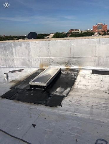 a skylight on a flat roof before being repaired 