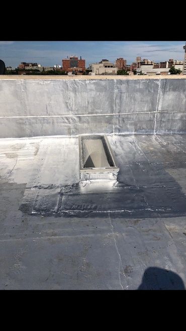a skylight on a flat roof after being repaired 