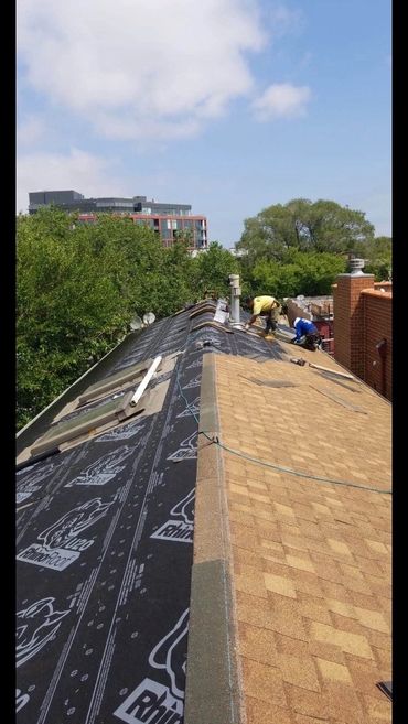 a shingle roof in down town Chicago by green world construction being installed  