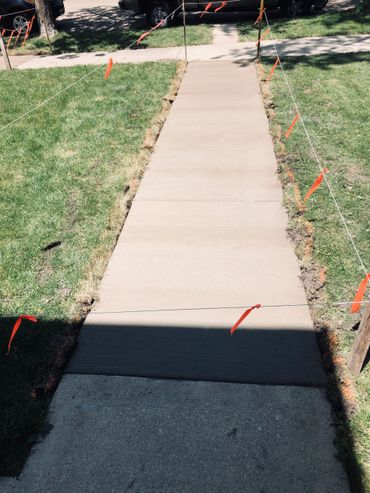 a concrete side walk installed by green world construction 