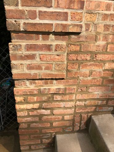 a brick wall after being Tuckpointing by green world construction