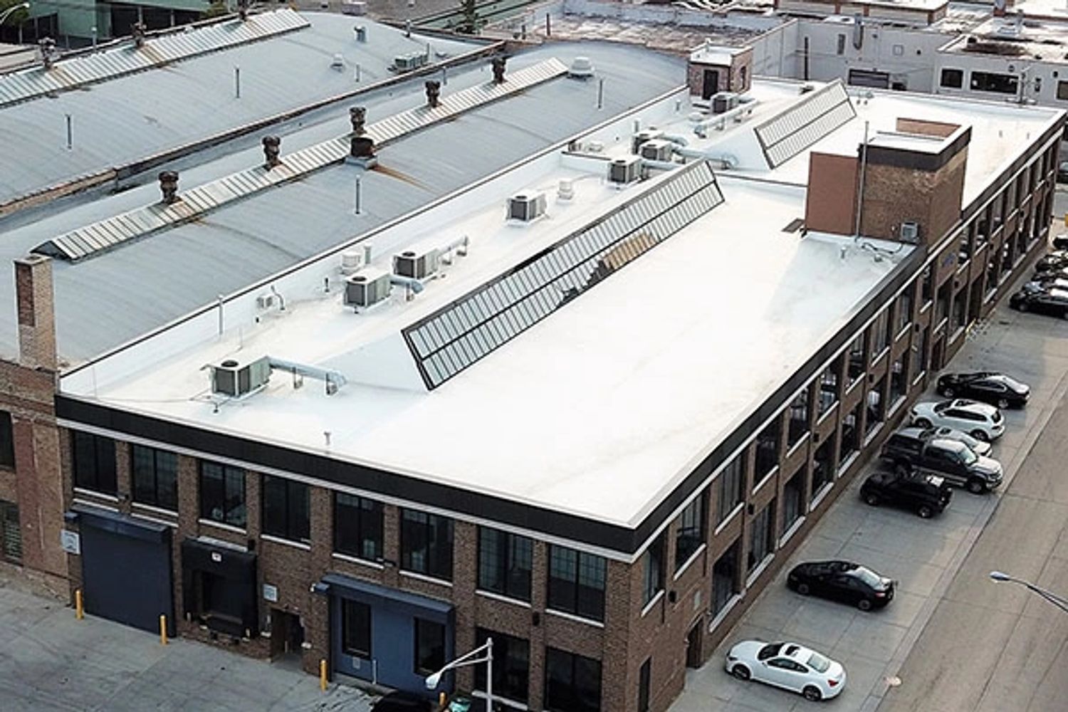 A commercial building rooftop illustrating types of roof repair.