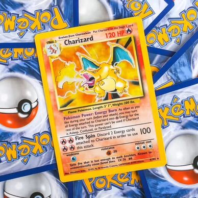 Charizard Pokémon card on top of several Pokémon card backs.