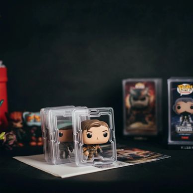 Funko Pop figures in protective cases with a dark background.
