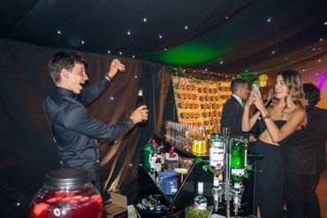 People enjoying a lively party with drinks and photos.