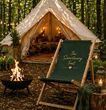 Cozy camping setup with a lit fire pit and a sanctuary tent in the woods.