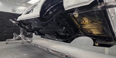 Restored car body frame in a workshop.