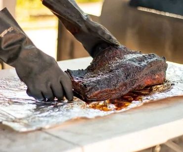 A Person Borking On A Brisket