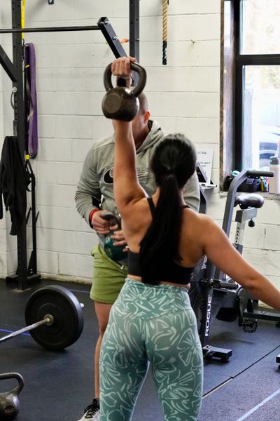 group training at RADD Fitness, Nutrition, and Recovery, kettlebell press