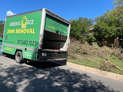 Green Source Junk Removal truck parked in front of yard waste 