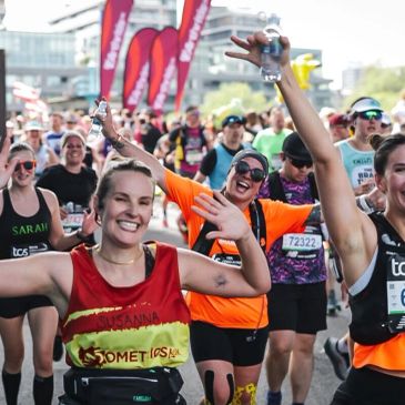 Runners happily participating in a marathon event.