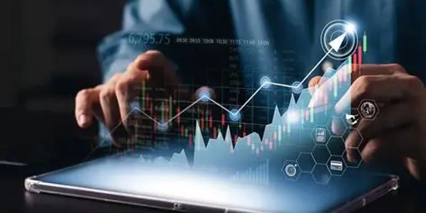 Hands interacting with a tablet displaying a rising financial graph.