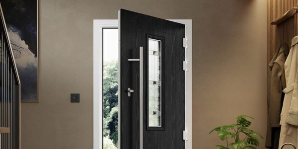 Modern black front door with glass panel partially open in a stylish entryway.