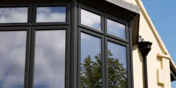 Reflective glass windows on a modern cream-colored building.