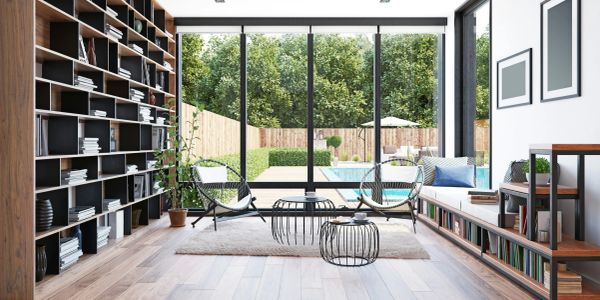 Modern living room with large windows overlooking a pool and garden.