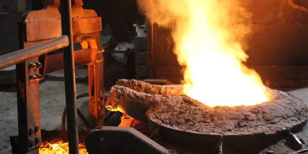 Molten metal glowing in an industrial furnace during smelting process.