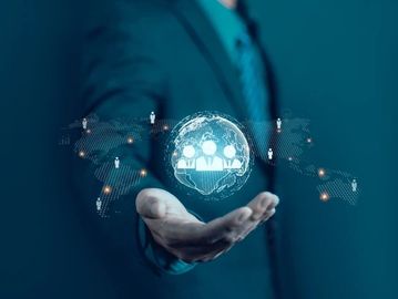 A businessman holding a digital globe with social network icons.