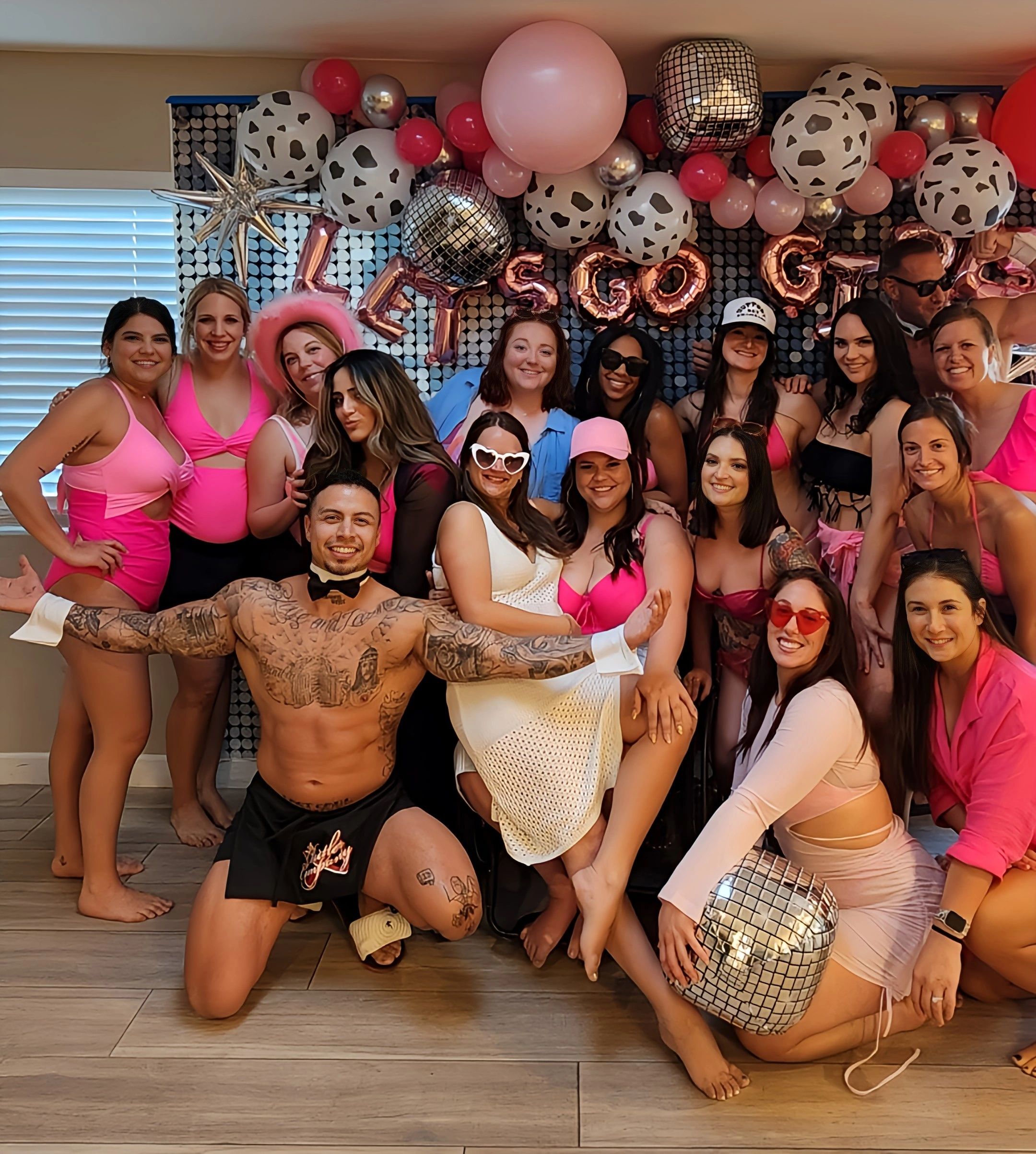 Fit party butler in New York poses for a photo with a beautiful bachelorette party