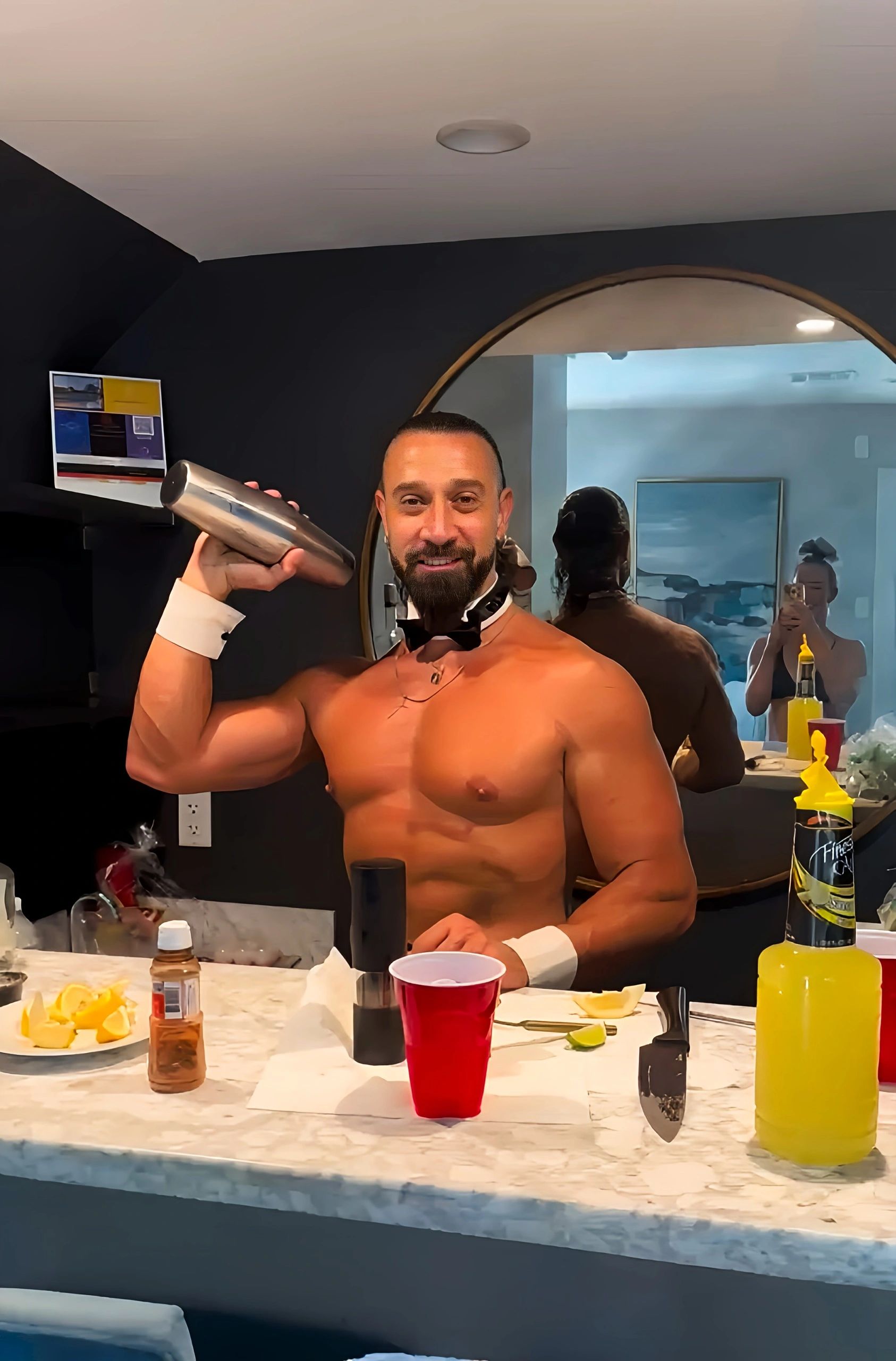 Buff butler in Boston mixes delicious cocktails for a fun bachelorette party at an Airbnb