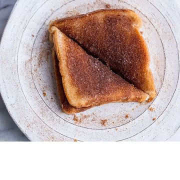 Two slices of cinnamon sugar toast on a white plate.