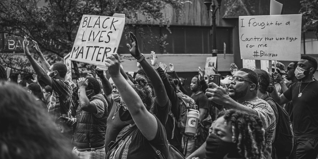Black Lives Matter protest with raised fists and signs.