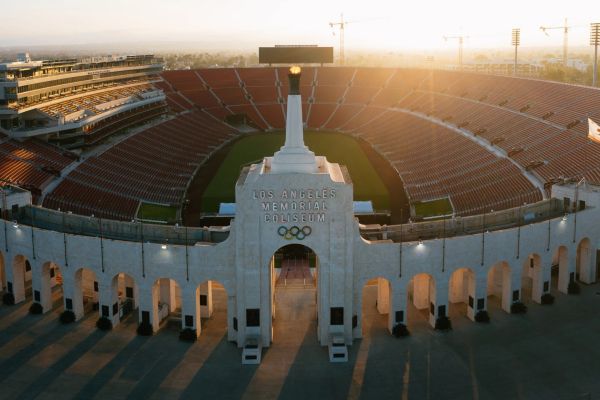 Los Angeles Memorial Coliseum at sunset with Olympic torch.