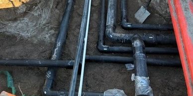 Underground plumbing pipes in a trench.