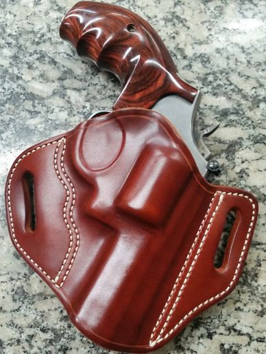 A brown leather holster and a gun