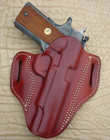 A brown leather holster and a gun