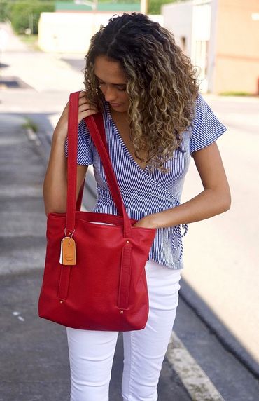 A view of a person carrying a blue leather bag