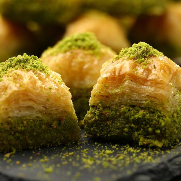 is a layered pastry dessert made of filo pastry, filled with chopped nuts, and sweetened with syrup