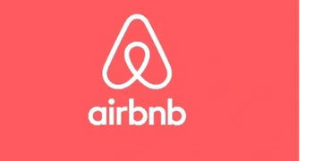 Airbnb logo on a red background.