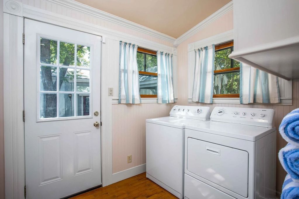 Laundry room with washer dryer ironing board 