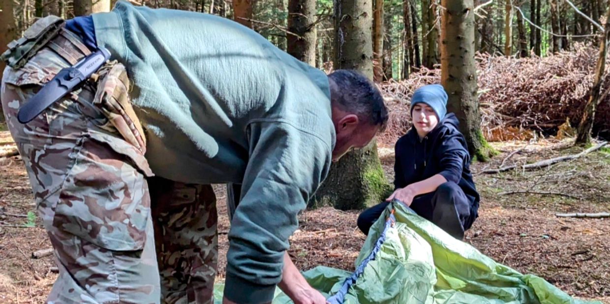 building a shelter on a bushcraft course