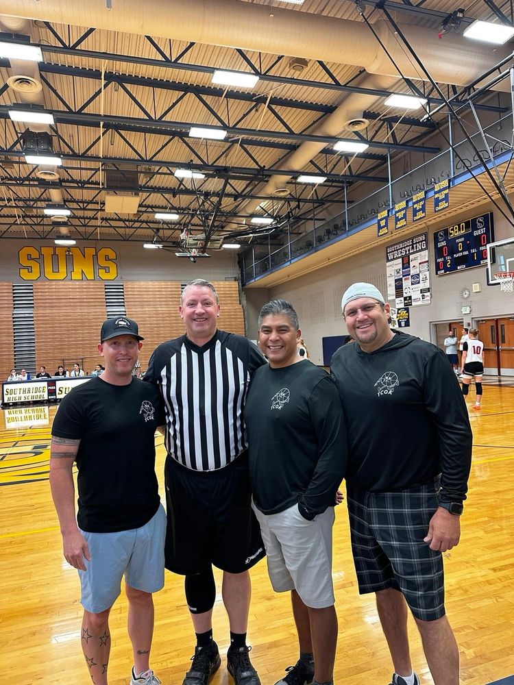 Forrest McKinnis smiling with TCOA camper and camp staff after a weekend basketball officiating camp
