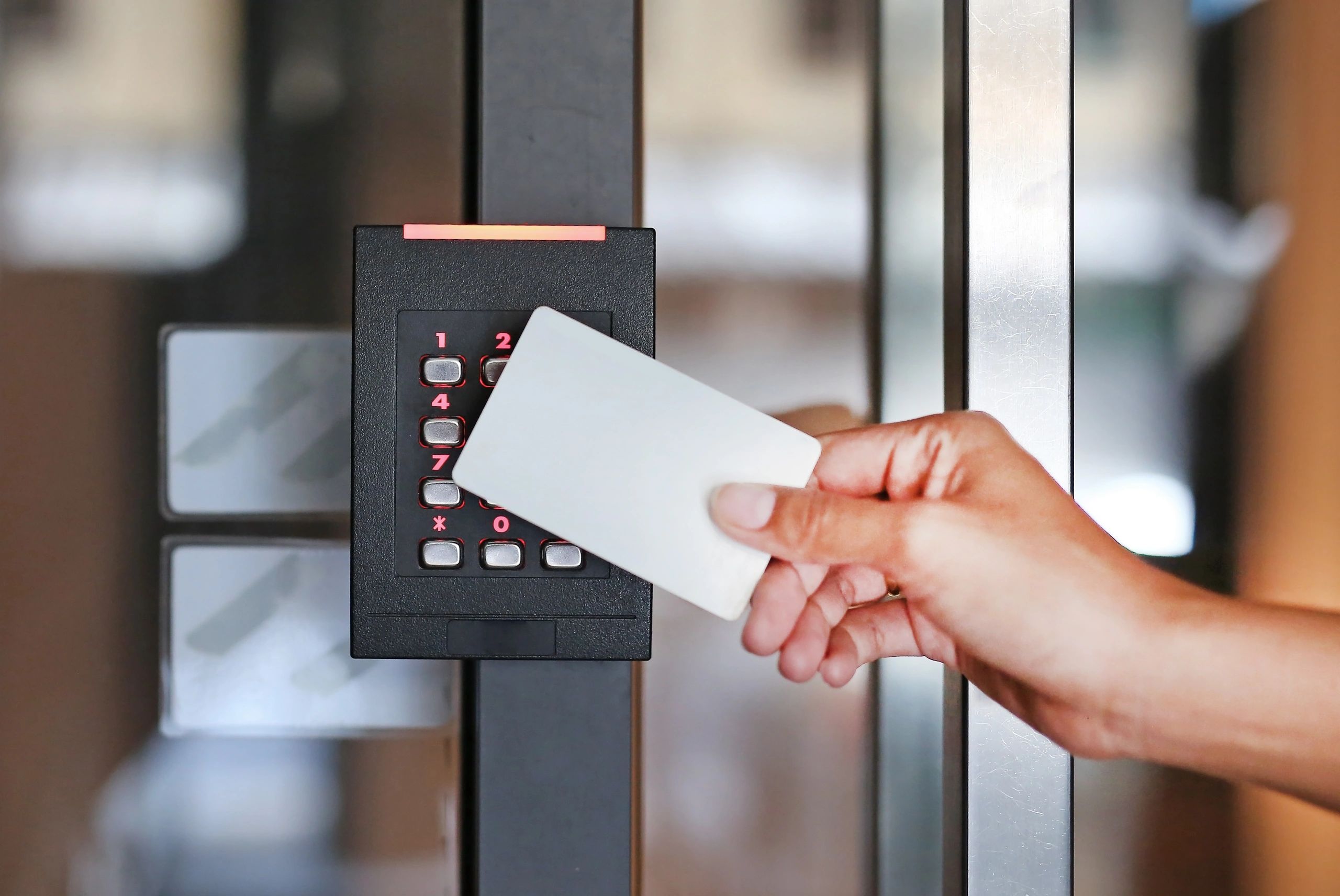 Person presenting a proximity card to a Wiegand keypad reader