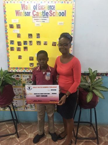Student and mother shows cheque received from Shirley Walters Memorial Scholarship