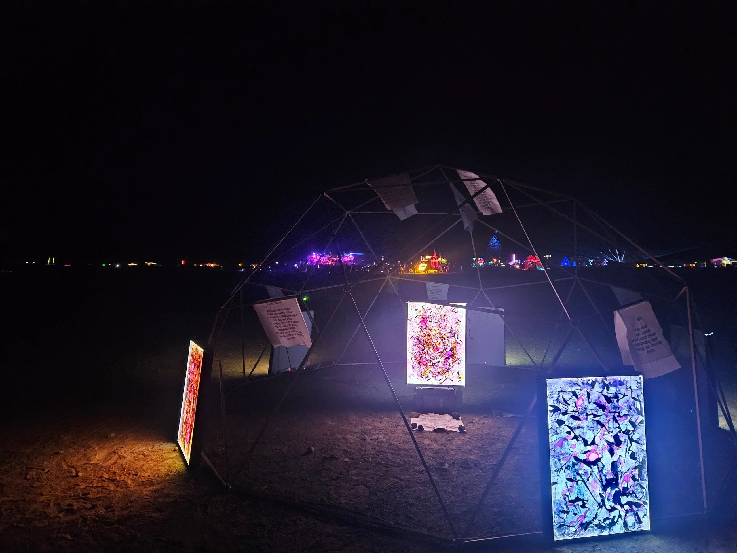 Illuminated art displays at night in a desert festival.