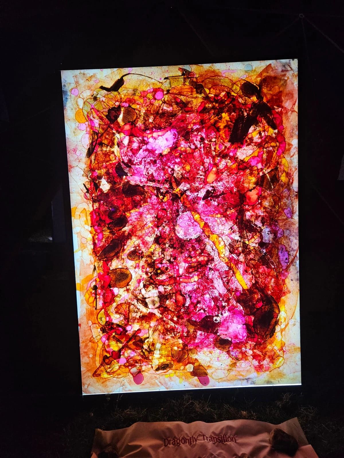 Bright abstract art with red, pink, and orange hues.