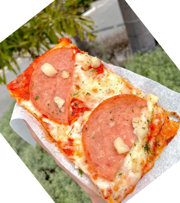 A slice of hawaiian pizza from Pizza Please, Italian Jamaican restaurant in Kingston Jamaica