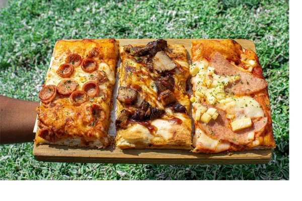 Pizza slices in Kingston Jamaica Ocho Rios with italian and jamaican toppings jerk chicken jerk pork