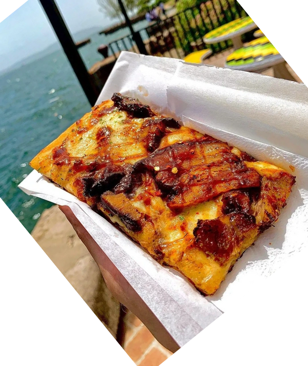 A slice of bbq barbecue pork pizza from Pizza Please, Italian Jamaican restaurant in Kingston waterf